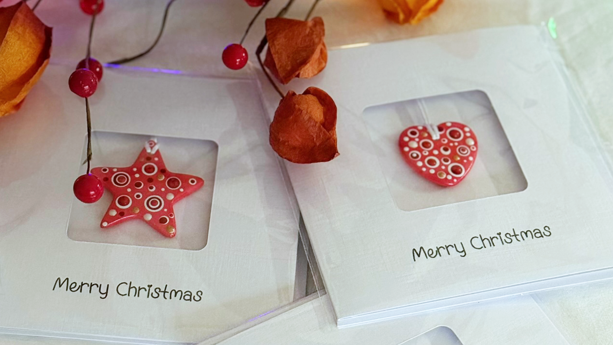Handmade ceramic Christmas keepsake cards with red star and heart ornaments
