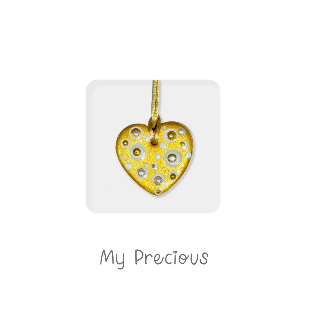 Handmade gold ceramic heart pendant with circle patterns on a keepsake card, gift for Valentine’s day