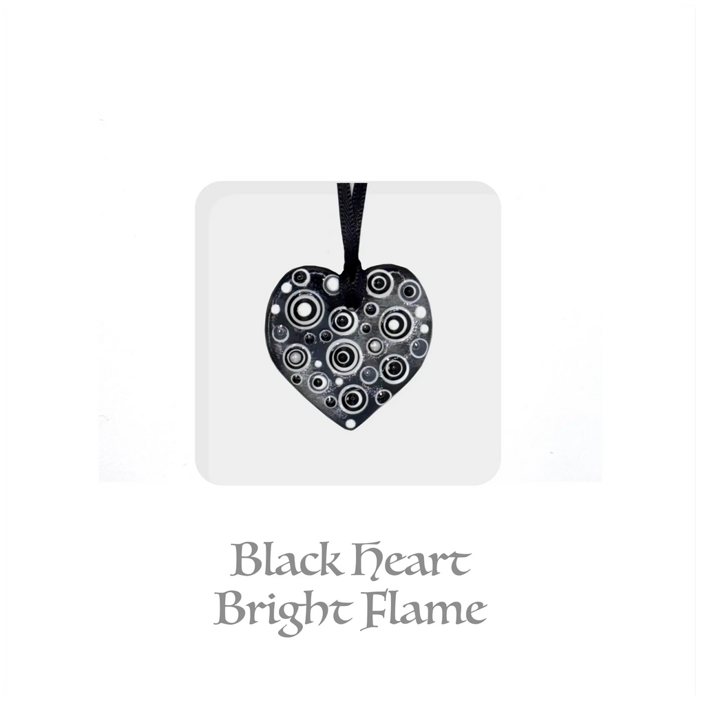 Handmade ceramic heart keepsake with black and white circular pattern, ribbon for hanging