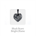 Handmade ceramic heart keepsake with black and white circular pattern, ribbon for hanging