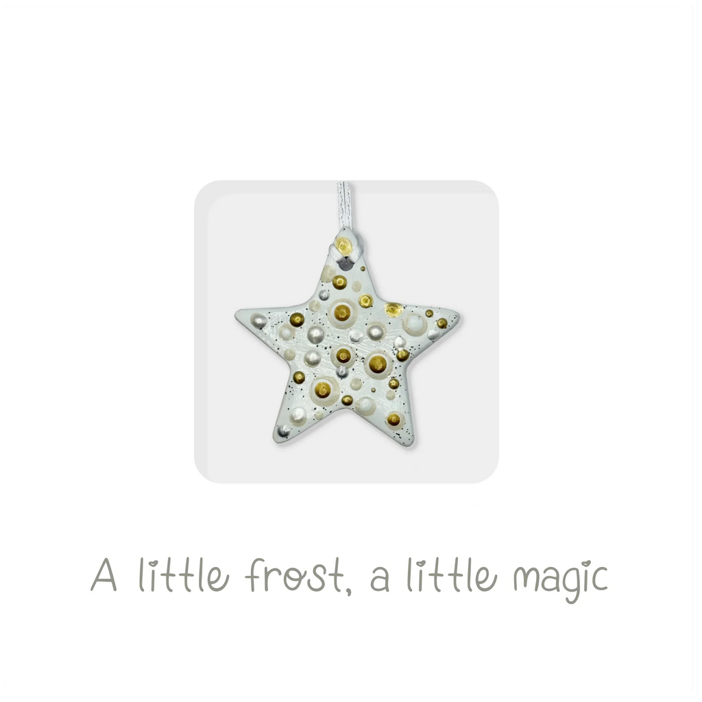 Handmade ceramic star ornament with gold and white accents, festive holiday card